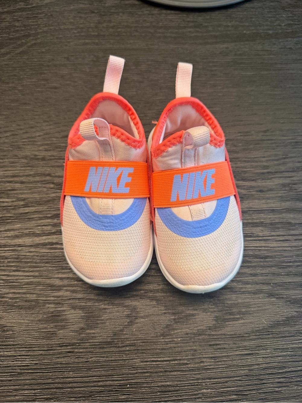 Nike Kids Slip-On Sneakers in Pink with Orange Strap and Blue Accent